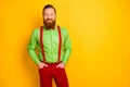 Photo of excited happy red head guy toothy smiling elegant look came party wear bright green shirt red suspenders bow Royalty Free Stock Photo