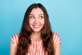 Photo of excited hopeful lady white smile dream look side empty space wear striped blouse isolated blue color background