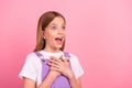 Photo of excited impressed little girl see black friday bargains promotion look empty space isolated on pink color Royalty Free Stock Photo