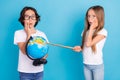 Photo of excited kids girl point globe palm cheek omg wow face wear white t-shirt isolated blue color background Royalty Free Stock Photo