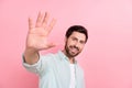 Photo of excited laughing young businessman have fun welcome wave palm high five hello friendly symbol isolated on pink