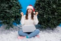 Photo of excited lucky girl dressed santa claus helper hat buying modern device x-mas fir  blue color background Royalty Free Stock Photo