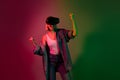 Photo of excited millennial lady playing video game on digital goggles winning isolated gradient neon color background Royalty Free Stock Photo