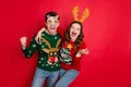 Photo of excited pair lady and guy chilling at newyear theme costume party wear funky knitted pullovers with ornaments