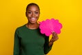 Photo of excited pretty young lady dressed green shirt pointing talking cloud empty space isolated yellow color Royalty Free Stock Photo