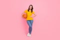 Photo of excited pretty young lady wear yellow t-shirt ready play basketball isolated pink color background Royalty Free Stock Photo