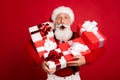 Photo of excited santa claus happy positive smile hold gift box christmas noel isolated over red color background Royalty Free Stock Photo