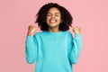 Photo of excited screaming african american young woman standing over pink background.