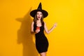 Photo excited spooky witch lady use smartphone point index finger copyspace mysterious boo enchant adverts wear black
