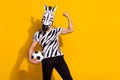 Photo of excited weird guy in zebra mask hold ball fist muscle up win world match isolated over bright color background