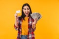 Photo of excited woman smiling while holding credit card and dollars Royalty Free Stock Photo