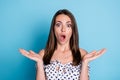 Photo of excited young girl open palms mouth shocked face wear dotted blouse isolated blue color background Royalty Free Stock Photo
