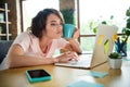 Photo of exhausted young girl cup coffee remote job browsing laptop overworked need more sleep isolated over interior Royalty Free Stock Photo