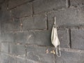 photo of face mask hanging on concrete wall with Noise or Film Grain