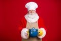 Photo of fairy stylish santa claus hold saucepan x-mas tradition meal wear chef cap red costume apron isolated over Royalty Free Stock Photo