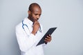 Photo of family doctor dark skin guy writing patient clipboard prescription test reading insurance details pharmacy wear