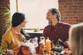 Photo of family thanks giving meeting served full dishes table greeting dinner young couple communicating living room Royalty Free Stock Photo