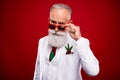 Photo of fancy aged grey hair man wear spectacles white jacket isolated on red color background Royalty Free Stock Photo