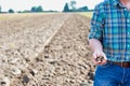 Farmer showing soil in farm