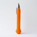 Bright Orange Knitted Pen: A Playful And Ironic Still Life