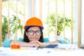 Photo of female engineer wearing orange helmet. Royalty Free Stock Photo