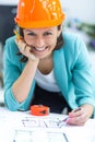 Photo of female engineer wearing orange helmet. Royalty Free Stock Photo