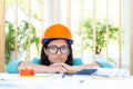 Photo of female engineer wearing orange helmet. Royalty Free Stock Photo