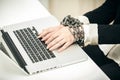 Photo of female hand chained up to laptop