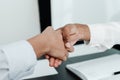 Photo of female hands. Businessmen conclude an agreement shaking hands over the table