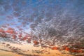 White-pink and fiery clouds on the blue sky