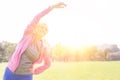 Flexible senior woman exercising on sunny day in park