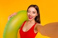 Photo of flirt cute woman wear swimsuit winking holding buoy tacking selfie isolated yellow color background Royalty Free Stock Photo