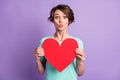 Photo of flirty cute young lady wear casual teal outfit holding big red heart lips pouted purple color