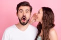 Photo of flirty girl whisper secret ear shocked excited man open mouth wear casual outfit isolated pink color background