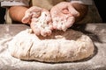 Photo of flour and women hands with flour. Cooking bread. Kneading the Dough. Isolated on dark background. Empty space for text Royalty Free Stock Photo