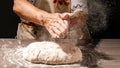 Photo of flour and women hands with flour splash. Cooking bread. Kneading the Dough.  on dark background. Empty space for Royalty Free Stock Photo