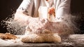 Photo of flour and women hands with flour splash. Cooking bread. Kneading the Dough. Isolated on dark background. Empty space for Royalty Free Stock Photo