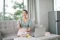 Photo of focused business woman hold pen sit sofa write notes fingers specs in home workstation indoors Royalty Free Stock Photo