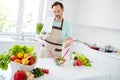 Photo of focused calm mature man cook salad add salt spices wear apron blue t-shirt home kitchen indoors