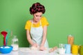 Photo of focused girl knead fresh pie cake dough table prepare home made dish wear yellow dotted t-shirt hair rollers Royalty Free Stock Photo