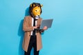 Photo of focused manager guy in lion mask typing netbook app search report over blue color background