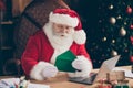 Photo focused santa claus prepare x-mas christmas night midnight event sit table open envelope read wish list letter Royalty Free Stock Photo