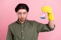 Photo of focused science worker guy showing flask wear goggles gloves khaki shirt isolated pink color background