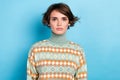 Photo of focused serious young girl calm face wear green sweater isolated on blue color background