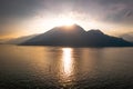 Photo of foggy mountains in Como lake with a sunset Royalty Free Stock Photo
