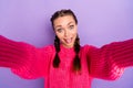 Photo of fooling childish young woman hold camera take selfie make funny face isolated on purple color background