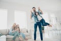 Photo of four members family moving round playful mood play game cozy apartments indoors Royalty Free Stock Photo