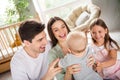 Photo of four positive excited people have good mood play toddler morning house indoors Royalty Free Stock Photo