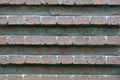 Photo of a fragment of a brick wall. Masonry with relief stripes.