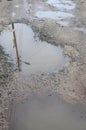 Photo of a fragment of a destroyed road with large puddles in rainy weathe